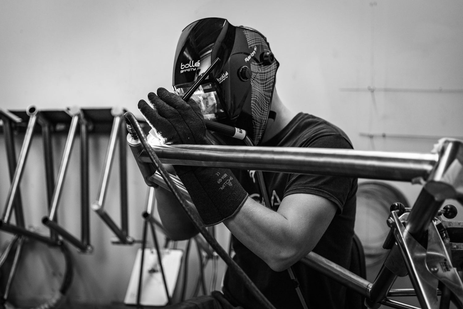 Titanium bicycle frame undergoing structural repair and alignment at Enigma