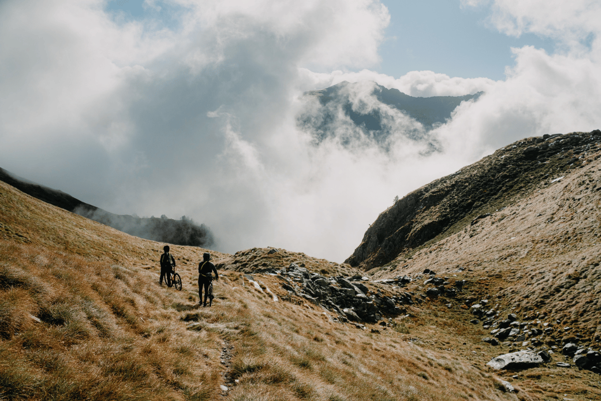Cyclists crossing remote mountain terrain during Lost Dot's Trans Pyrenees ultra distance race