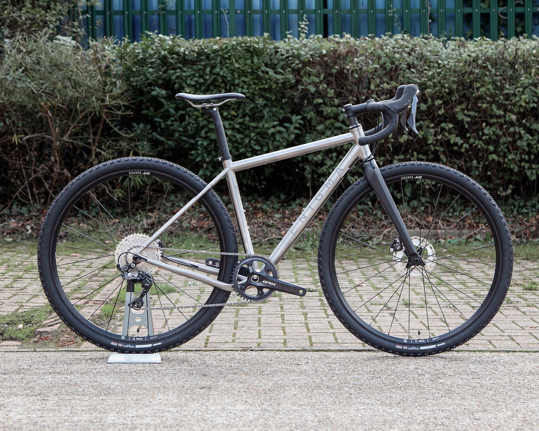 Enigma 50cm Edge MK.II titanium gravel bike, side profile showing brushed 3Al/2.5V titanium frame, Shimano GRX Di2 groupset, DT Swiss GR1800 wheels and C-Six carbon fork.