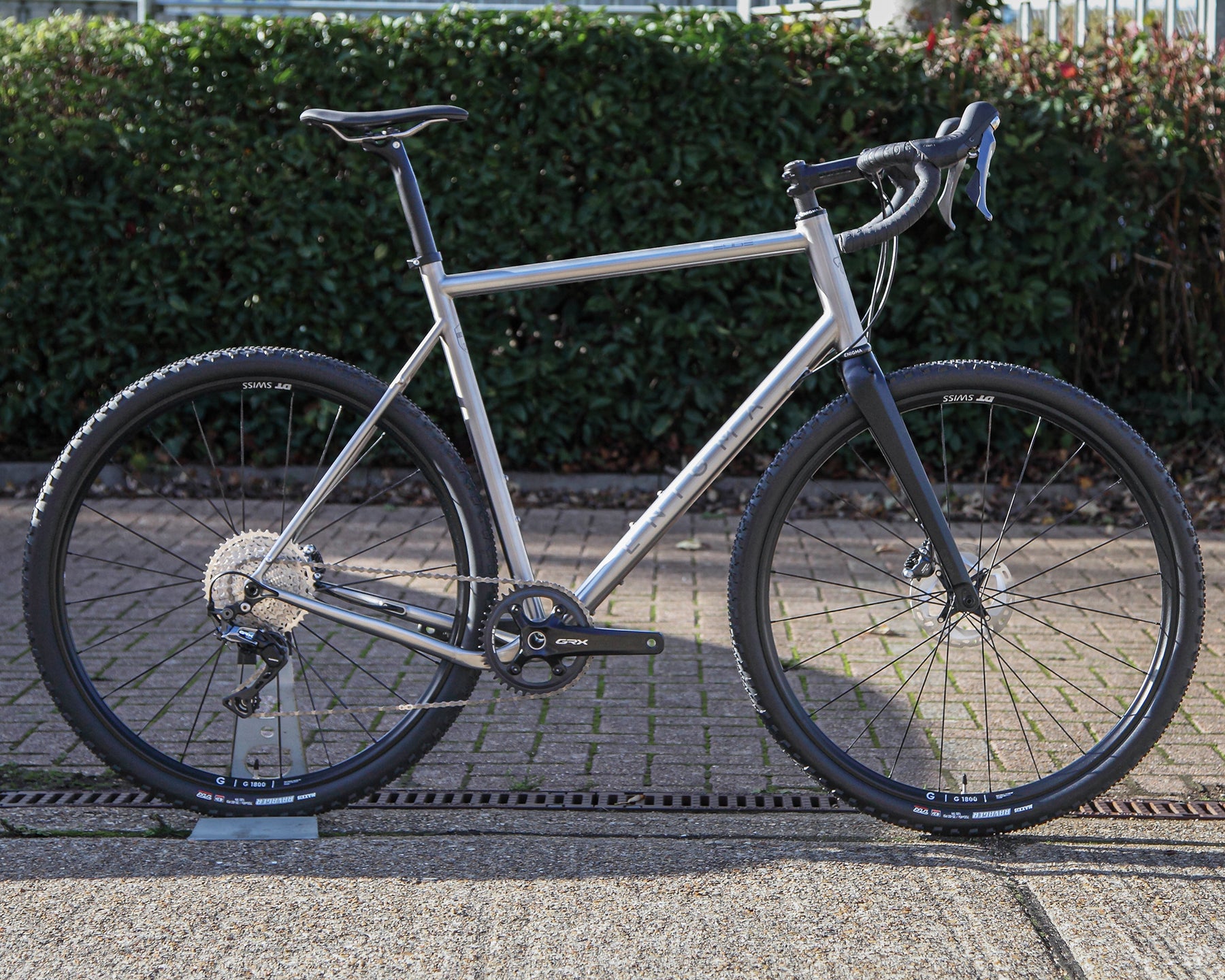 Enigma Edge MK.II titanium gravel bike, size 60cm, side profile showing brushed 3Al/2.5V titanium frame, Shimano GRX Di2 groupset, DT Swiss GR1800 wheels and C-Six carbon fork.