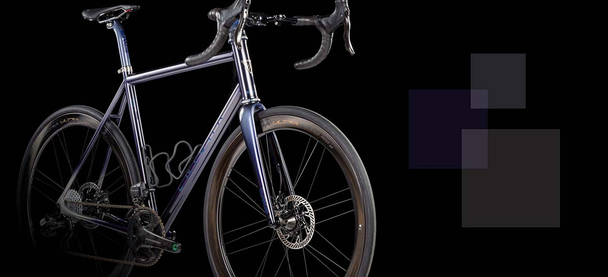 Enigma Signature Eikon titanium road bike with disc brakes on black background