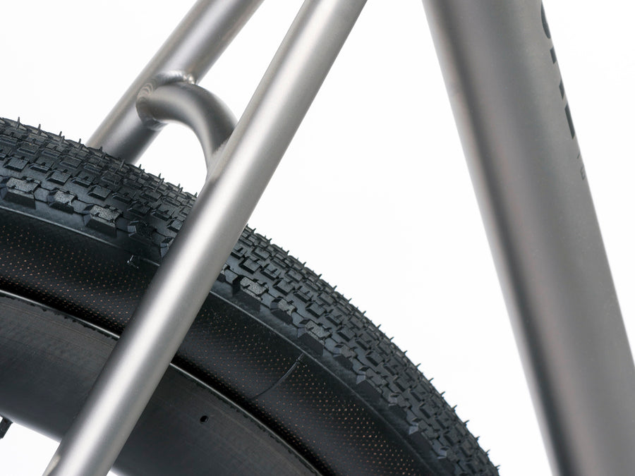 Enigma Eremos titanium gravel bike showing high-volume gravel tyre clearance