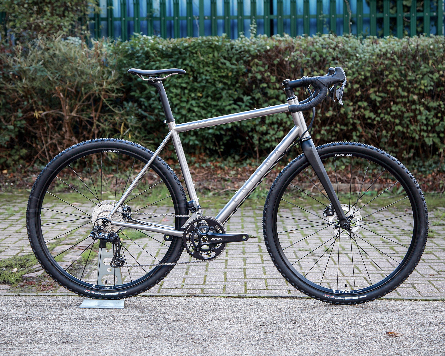 Enigma Escape MK.III titanium gravel bike, side profile showing brushed titanium frame, Shimano GRX Di2 groupset, DT Swiss wheels and C-Six carbon fork.