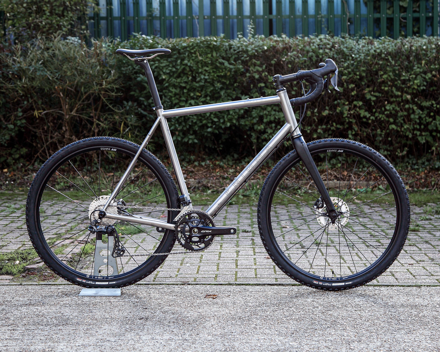 Enigma Escape MK.II titanium gravel bike, side profile showing brushed titanium frame, Shimano GRX Di2 groupset, DT Swiss wheels and C-Six carbon fork.