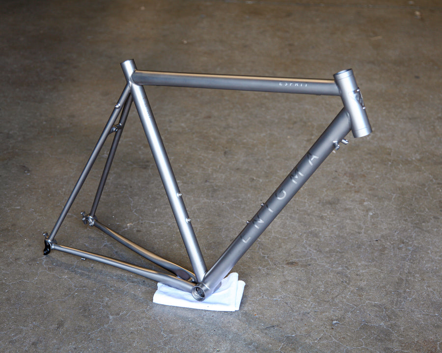 Enigma Esprit 54cm UK-handcrafted titanium road frame with satin bead finish, brushed logos, horizontal top tube and external cable routing.