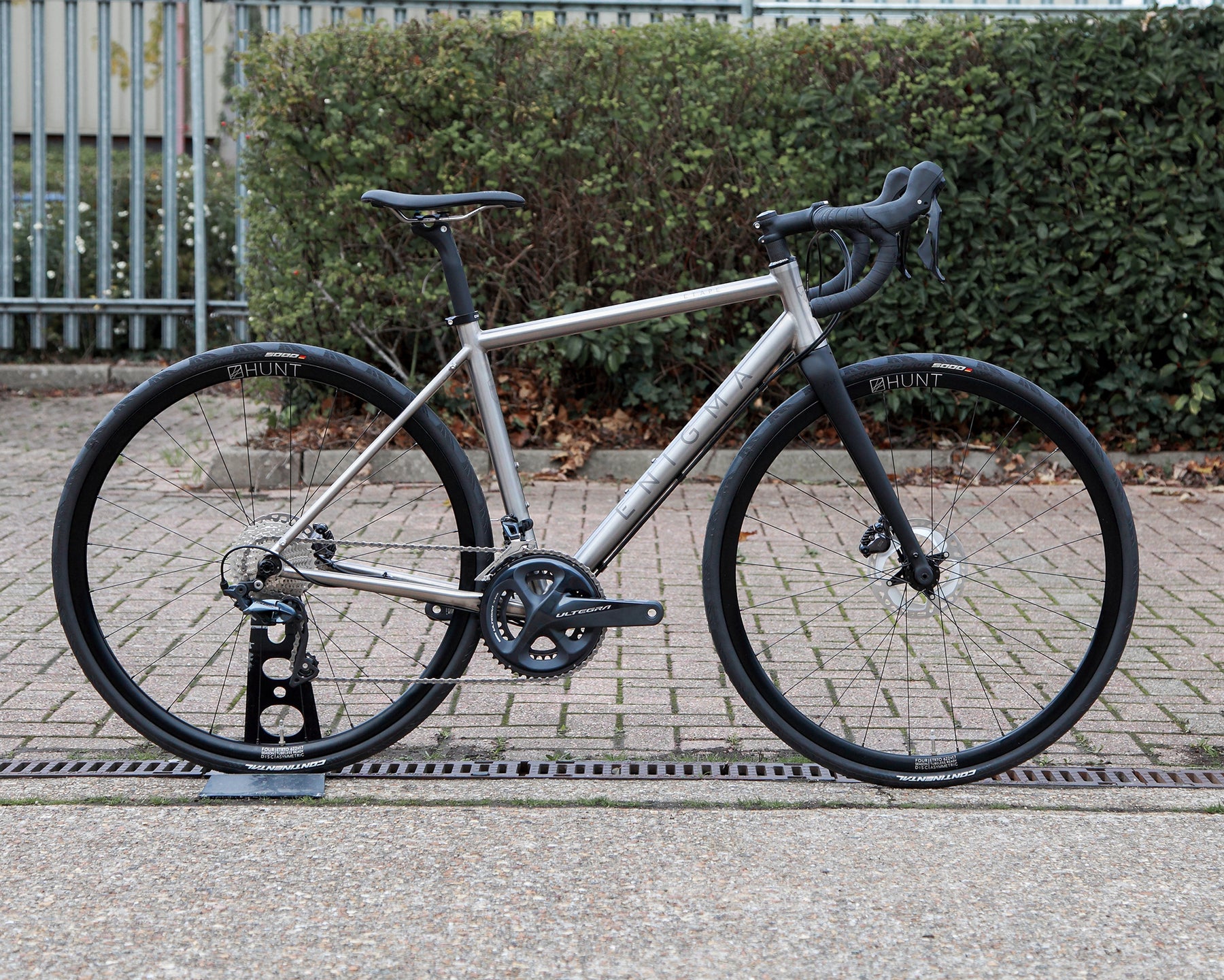 Enigma Etape 52cm ex-demo titanium all-road bike, side-on view showing brushed titanium frame, Shimano Ultegra 11-speed drivetrain, C-Six ADX carbon fork and Hunt 4 Season wheels.